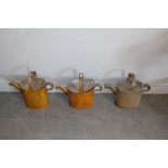 Three vintage grained/scumbled watering cans, 48cm accumulated dirt, marks etc but generally good