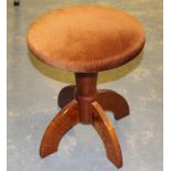 A modern mahogany revolving piano stool, the circular padded top over the plastic revolving