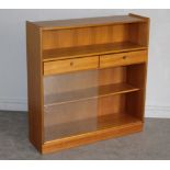 A 1970's teak bookcase by Nathan, with open section over two drawers and sliding glass doors