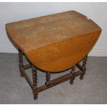 An oak barley-twist gate-leg table 72cm x 91cm x 52cm the top heavily marked.