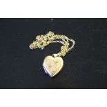 A 9ct gold heart-shaped locket pendant and fine yellow metal chain 4.3grams gross, chain knotted,