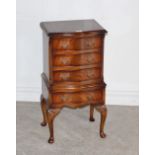 A reproduction serpentine-fronted mahogany chest of drawers, of small proportions, with three