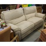A modern two seater recliner settee, with piped material upholstery and manual reclining mechanism