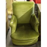 An early 20th century green dralon upholstered armchair, 92cm damage to seat springs.