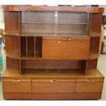 A 1970's glazed teak room unit, 165cm x 177cm used condition some damage.