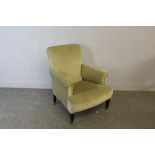 An Edwardian green dralon upholstered armchair, with scrolled-out arms and sprung seat raised on