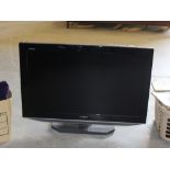 A Sharp flatscreen television, 32" used, lacking remote control.
