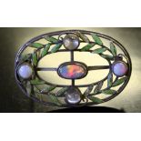 An Edwardian white metal, enamel, opal and moonstone brooch, of oval form with central oval opal