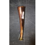 A copper and brass hunting horn, of slightly curned and flared cylindrical form, marked 'Made In