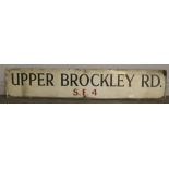 A vintage enamelled street sign 'Upper Brockley Rd S.E.4' 137cm x 25.5cm some enamel losses and