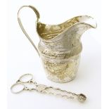 Thomas Wheatley 18th century milk jug (Newcastle) together with a pair of silver sugar nips, both