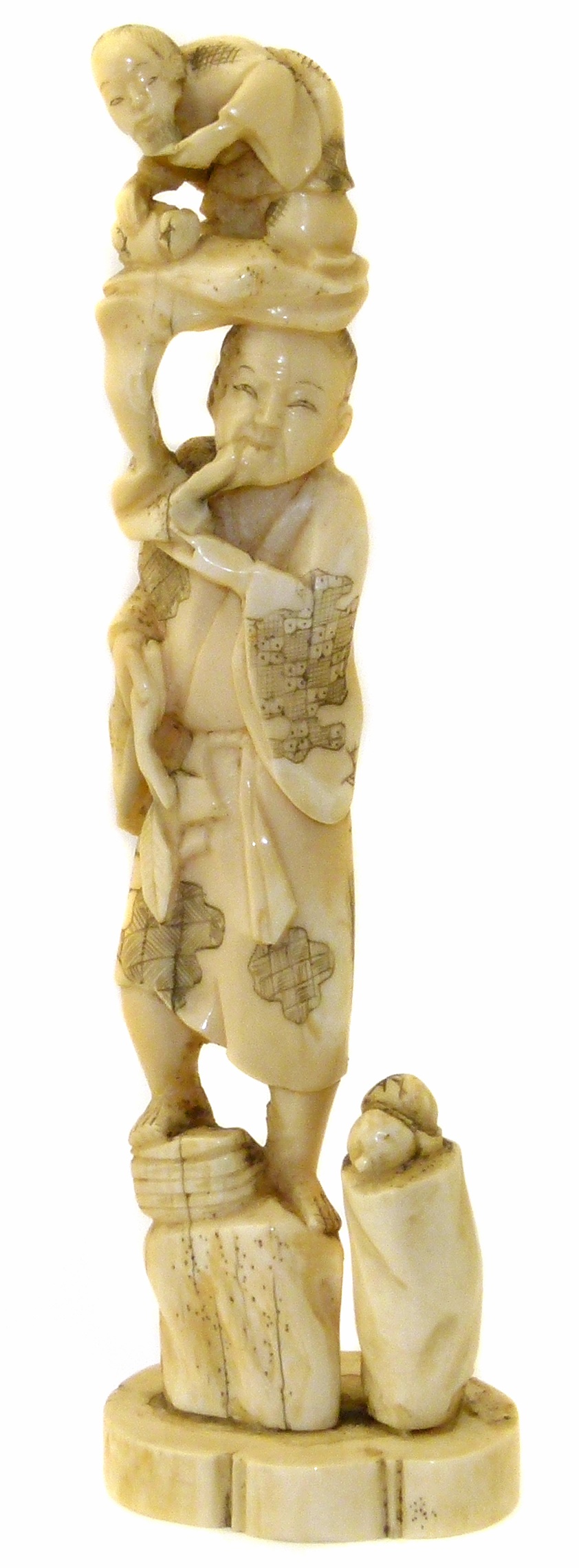 A Japanese Meji Period walrus ivory okimono, depicting a sage carrying another figure, signed,