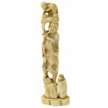 A Japanese Meji Period walrus ivory okimono, depicting a sage carrying another figure, signed,