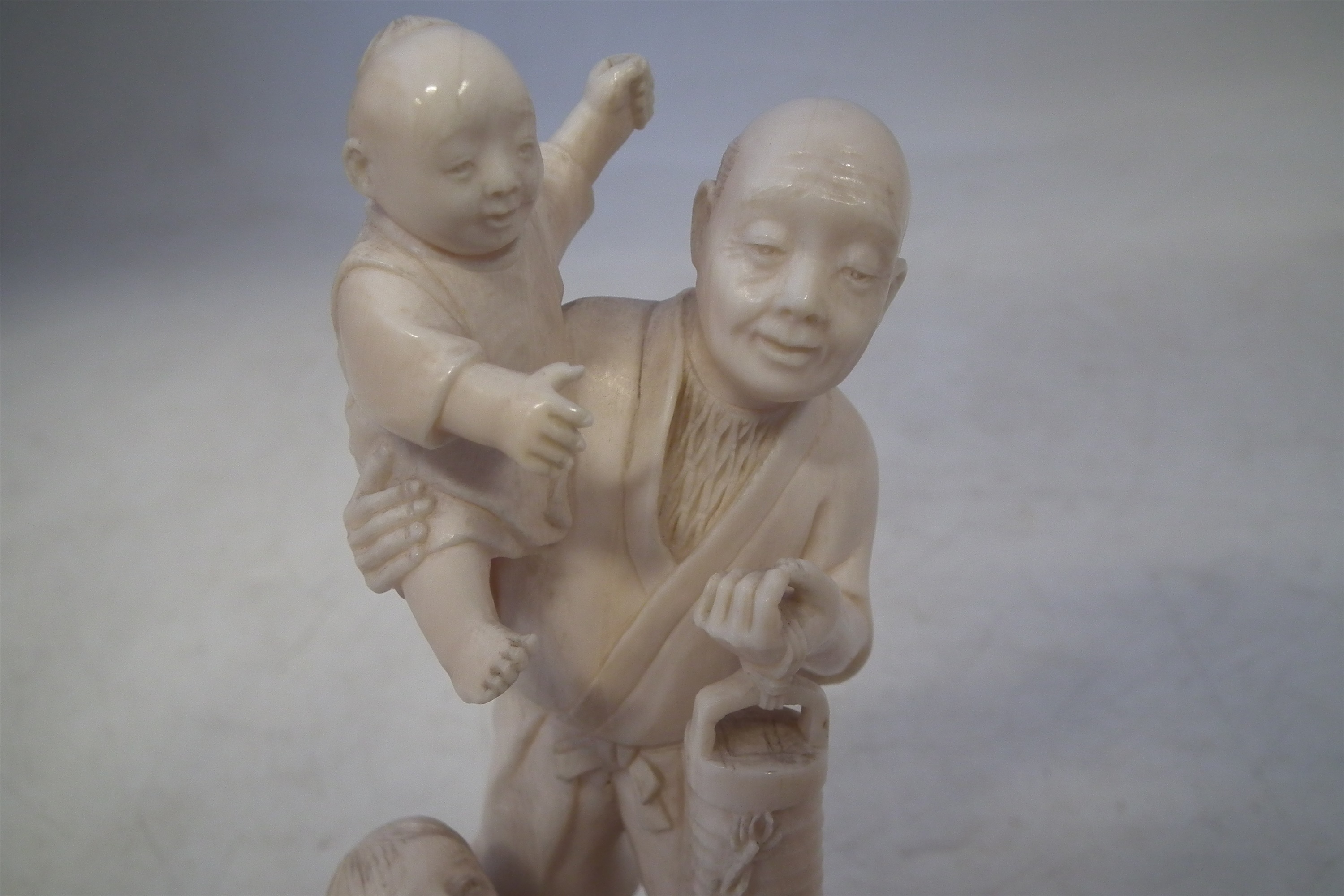 Japanese Ivory okimono, depicting a father and his two sons carrying a lantern with a dog at the - Image 2 of 11