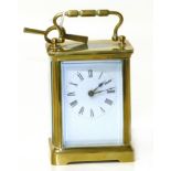 Early 20th century brass carriage clock with enamel face and Roman numerals complete with winder