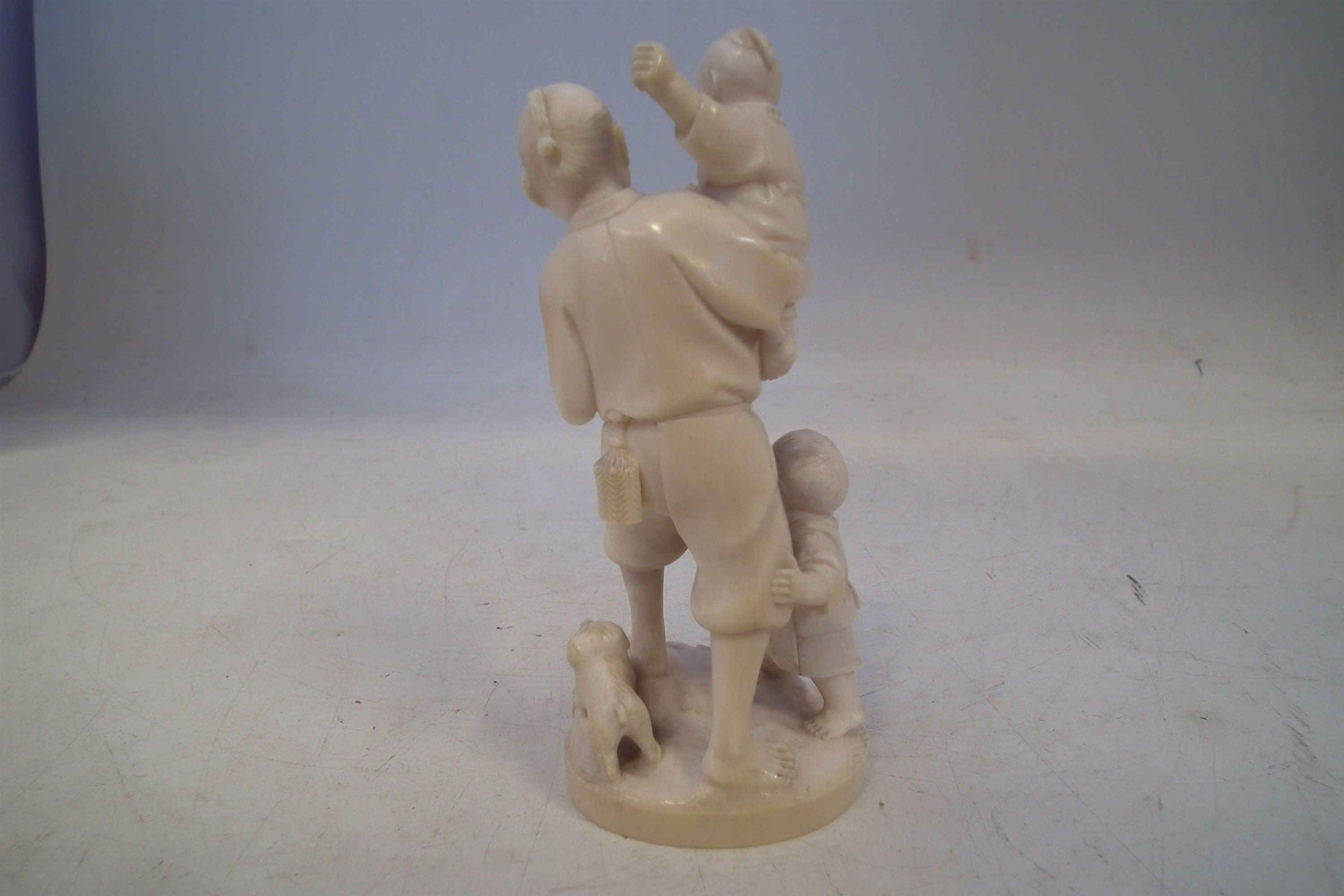 Japanese Ivory okimono, depicting a father and his two sons carrying a lantern with a dog at the - Image 7 of 11