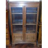 Early 20th century oak two door glazed bookcase, 76cm wide. We are unable to do condition reports on