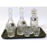 Pair of cut glass wine/sherry decanters, cut glass whisky decanter and three Birmingham silver