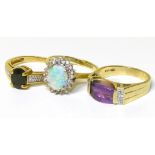 Three gem set dress rings, to include an amethyst and diamond dress ring, a sapphire and diamond