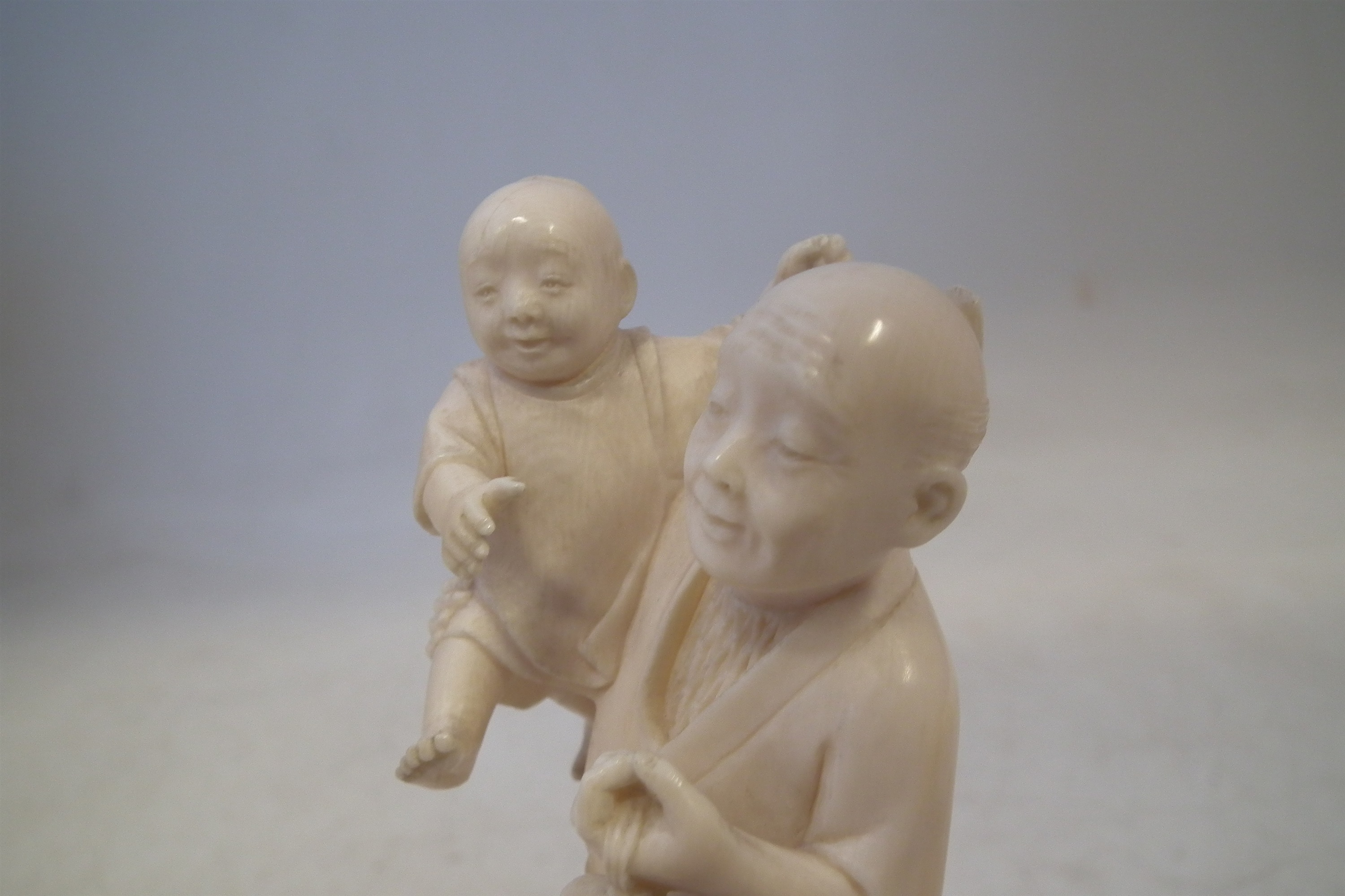 Japanese Ivory okimono, depicting a father and his two sons carrying a lantern with a dog at the - Image 5 of 11