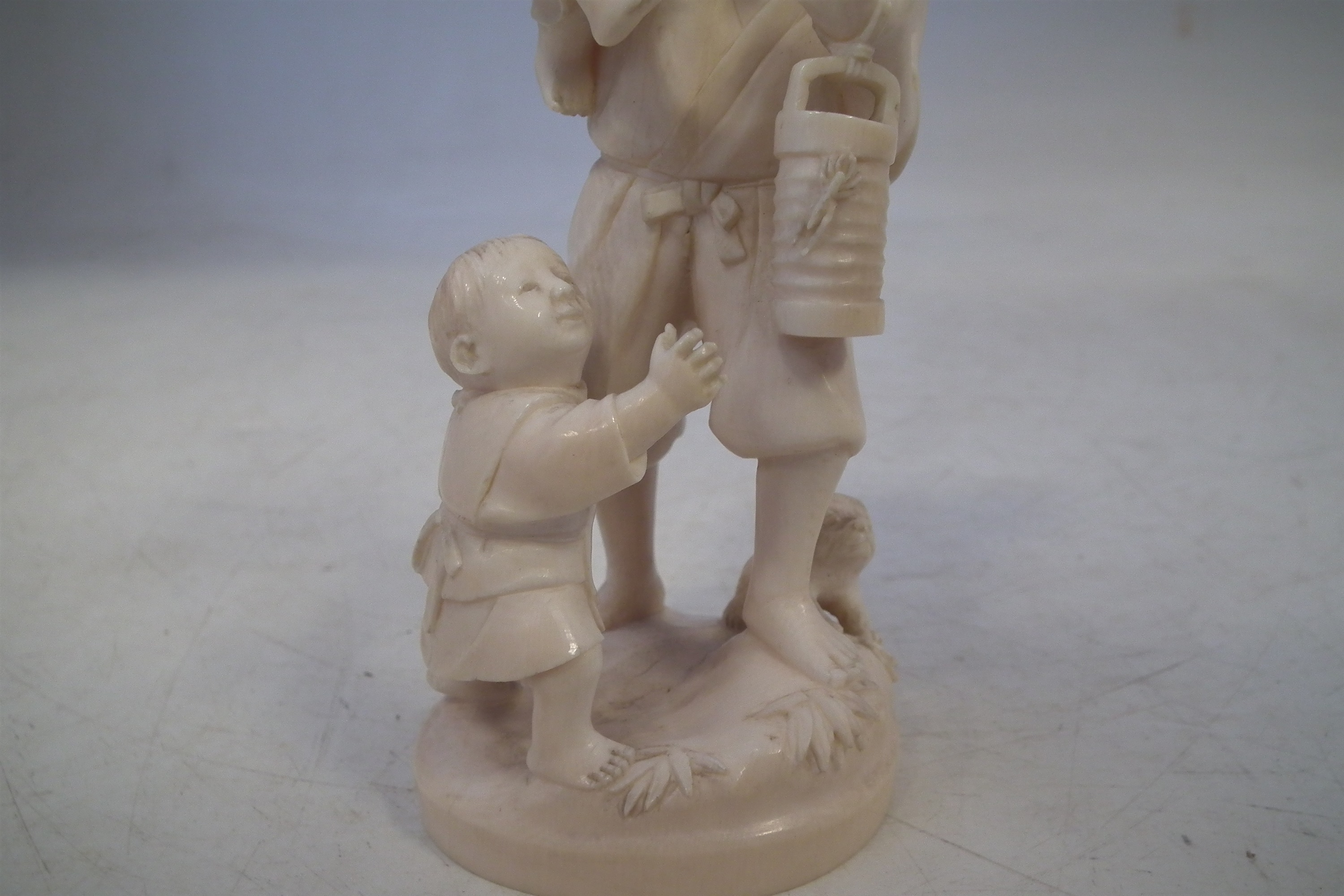 Japanese Ivory okimono, depicting a father and his two sons carrying a lantern with a dog at the - Image 4 of 11