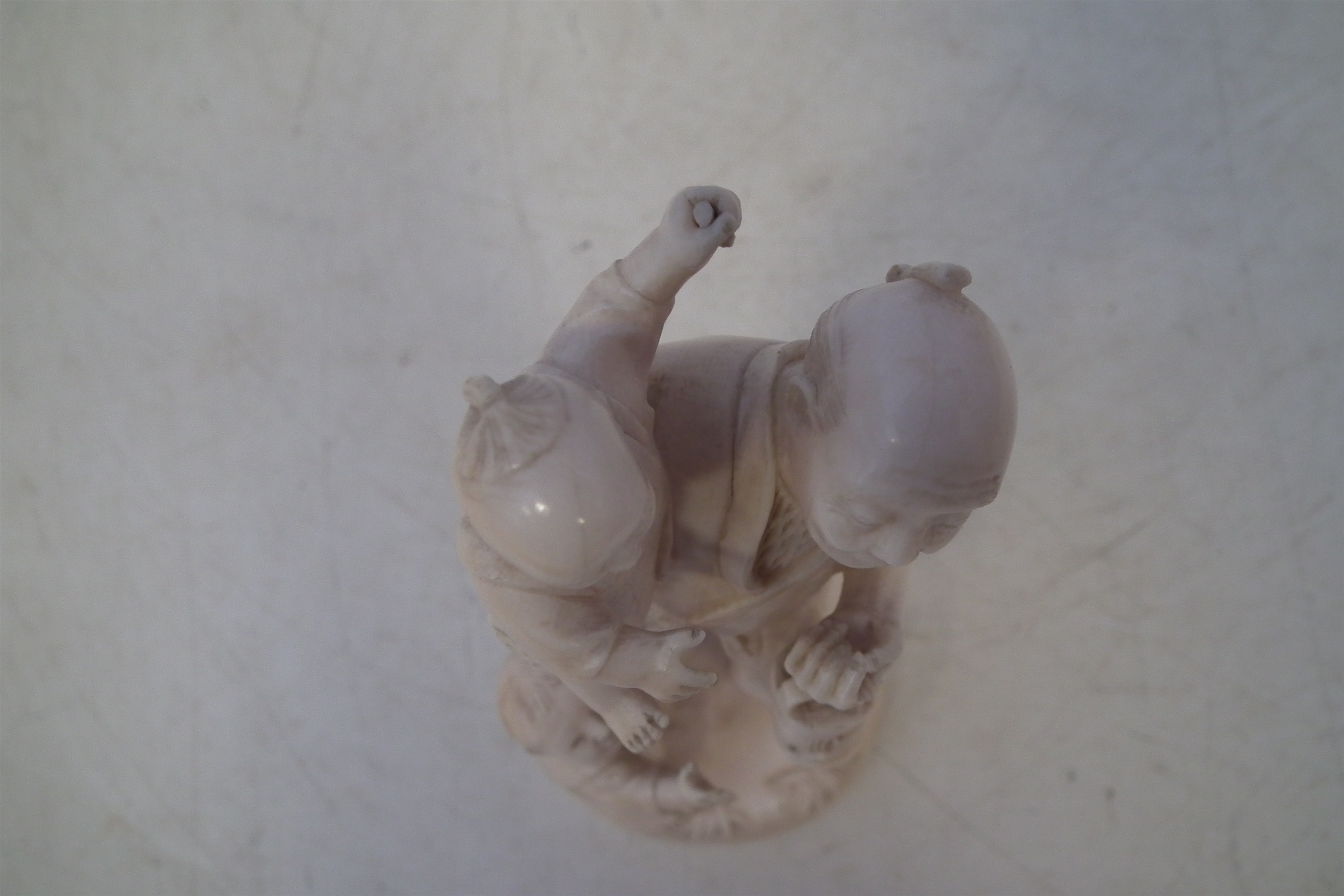 Japanese Ivory okimono, depicting a father and his two sons carrying a lantern with a dog at the - Image 3 of 11