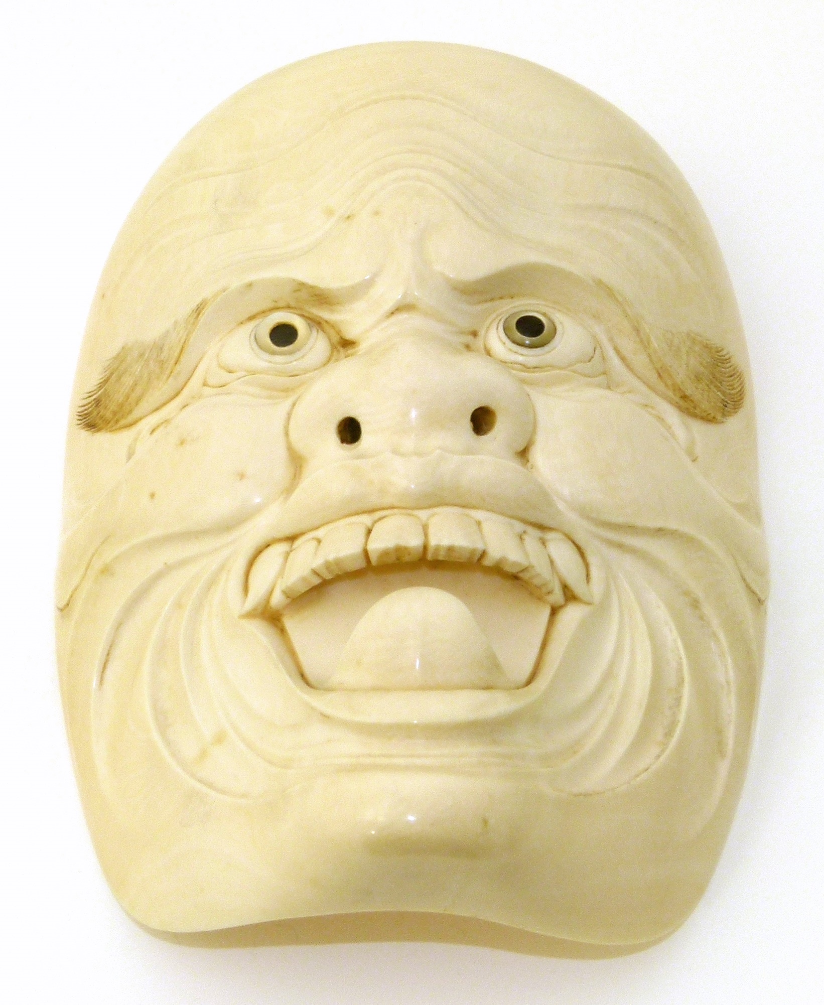 A Japanese Meiji Period carved ivory Noh mask, with mother-of-pearl eyes, unsigned, dimensions 11.
