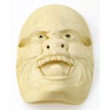 A Japanese Meiji Period carved ivory Noh mask, with mother-of-pearl eyes, unsigned, dimensions 11.