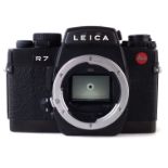 Leica R7 SLR Camera body, serial number 1909805, with Nikon ever ready case. CONDITION REPORT: We