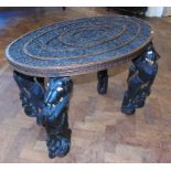 Early 20th century Burmese hardwood occasional table on four legs of stylised Lions. We are unable