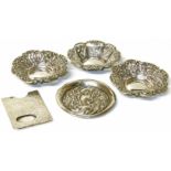 Three Birmingham silver nut dishes, 8cm diameter, small silver embossed dish and silver card holder.