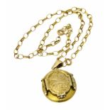 A yellow metal locket, the oval hinged locket suspended from two 9ct gold trace link chains, gross
