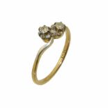 A diamond crossover ring, the brilliant cut diamond duo with scrolling shoulders, stamped 18ct, ring