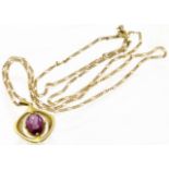 A 9ct gold purple paste pendant, the oval shape purple paste within a textured surround, suspended