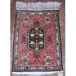 Iranian Qum silk rug, pink field with oval central medallion, floral decoration, blue, green, yellow
