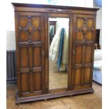 Early 20th century oak Jacobean style triple wardrobe with mirrored centre door Condition reports