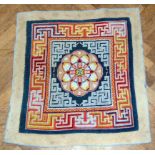 Early 20th Tibetan wool bag, panel back indigo blue field with central rosette, geometric border,