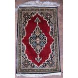 Iranian Qum silk rug, madda field, central medallion and matching floral spandrels, green border,