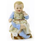 19th century continental bisque figure of a seated child 32cms high Condition reports are not