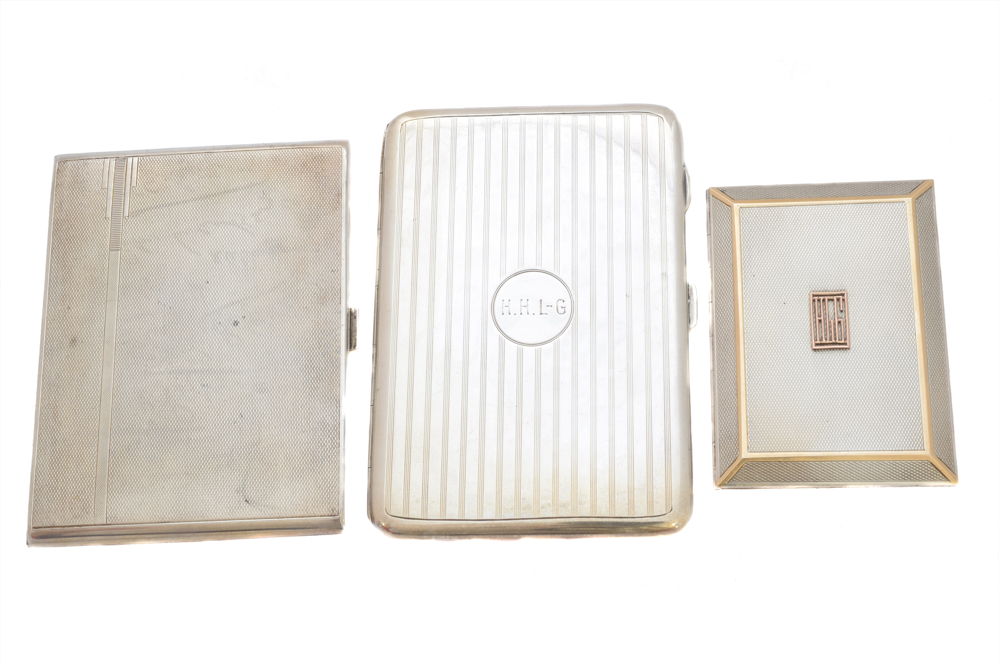 Three silver cigarette cases.