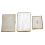 Three silver cigarette cases.