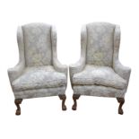 A pair of early 20th century wing-back Georgian style deep seated chairs