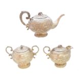 An Indian white metal three piece tea set,