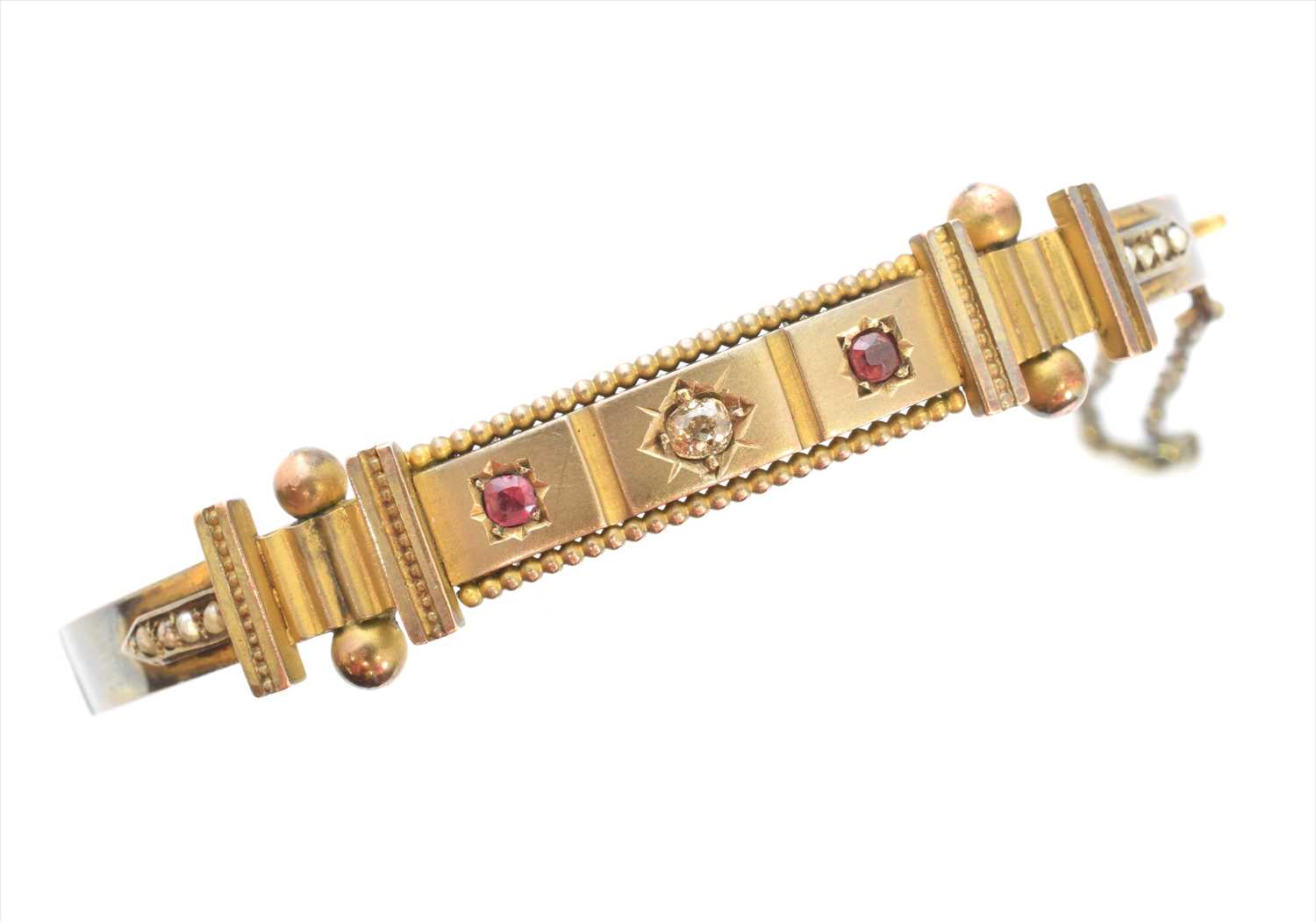 A late Victorian diamond, ruby and split pearl bangle,