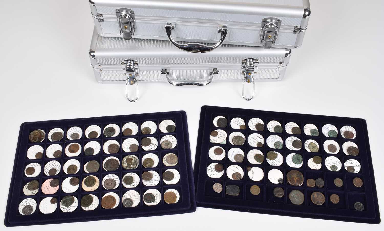 Collection of ancient Roman and Egyptian coins and two coin cases.