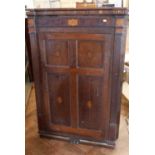 George III oak and cross-banded corner cupboard with shaped interior shelves and hidden compartment