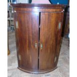 George III mahogany bow fronted corner cupboard