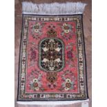 Iranian Qum silk rug, pink field with oval central medallion, floral decoration, blue, green, yellow