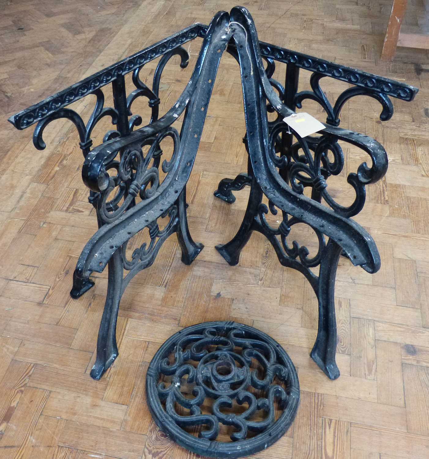 Pair of bench ends and table ends and parasol base.