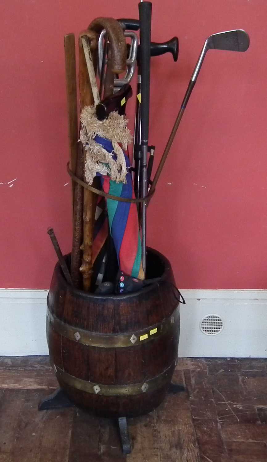 Oak barrel stick stand with centre column guide and quantity of sticks and two yard sticks etc.